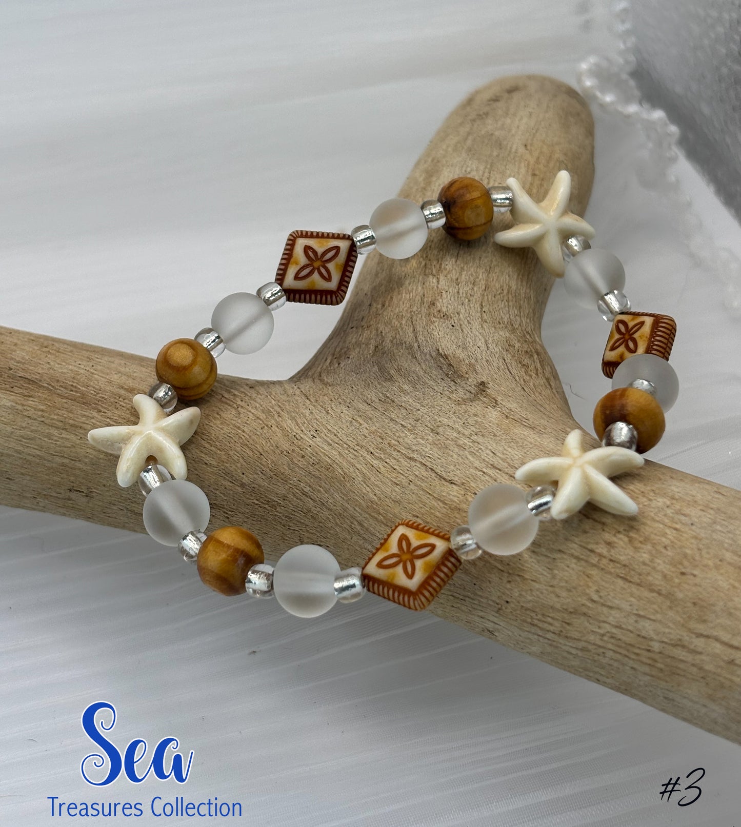 Bracelet with starfish and wooden bead design on a branch, featuring 'Sea Treasures Collection' branding.