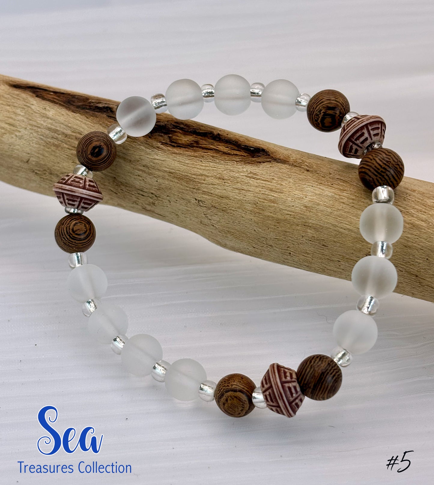 Bracelet with white beads and brown wooden beads on a white background