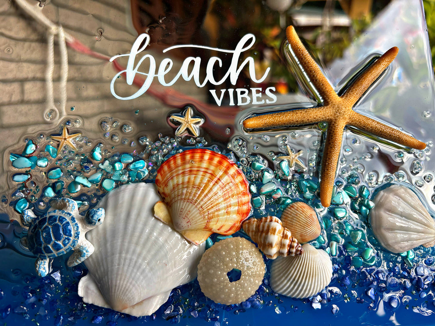 Seashells, starfish, and decorative elements with 'beach vibes' text on a blue and clear background.