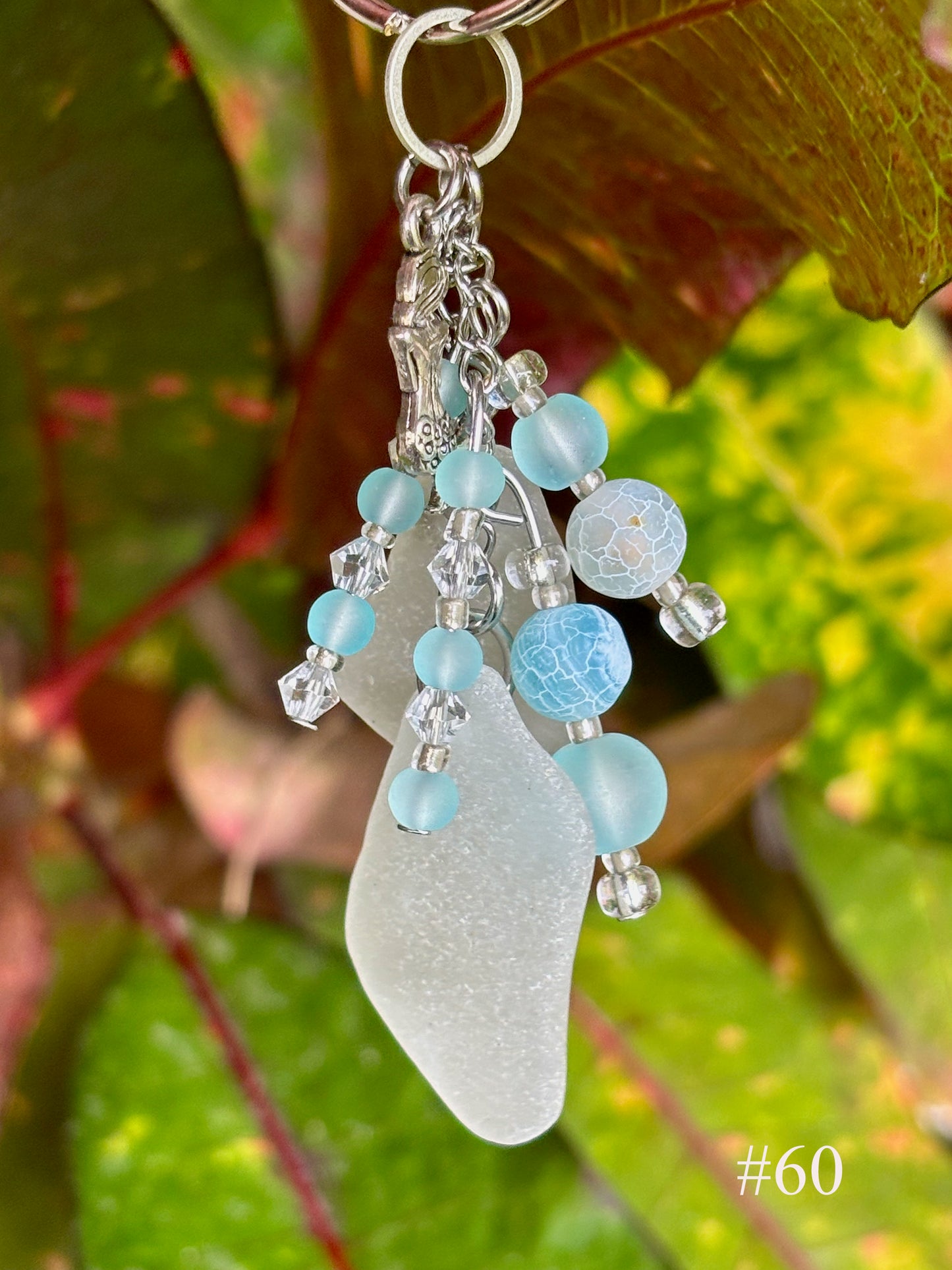 Keychain with sea glass and beads against a leafy background