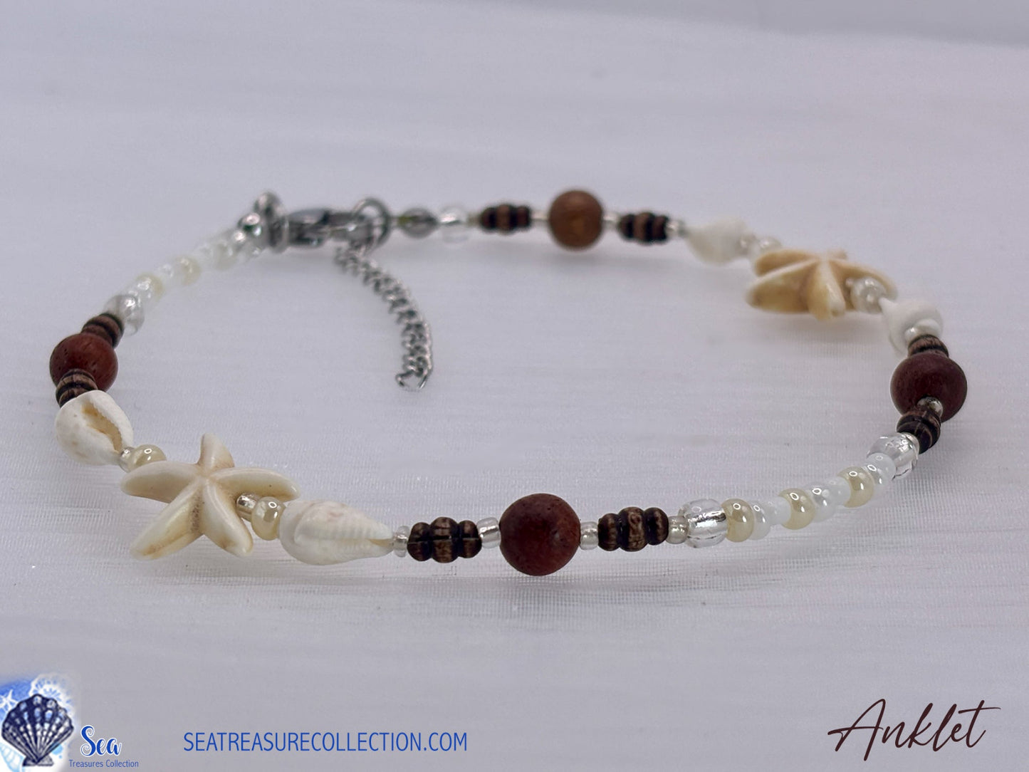 Beaded anklet with starfish and shell designs on a white background