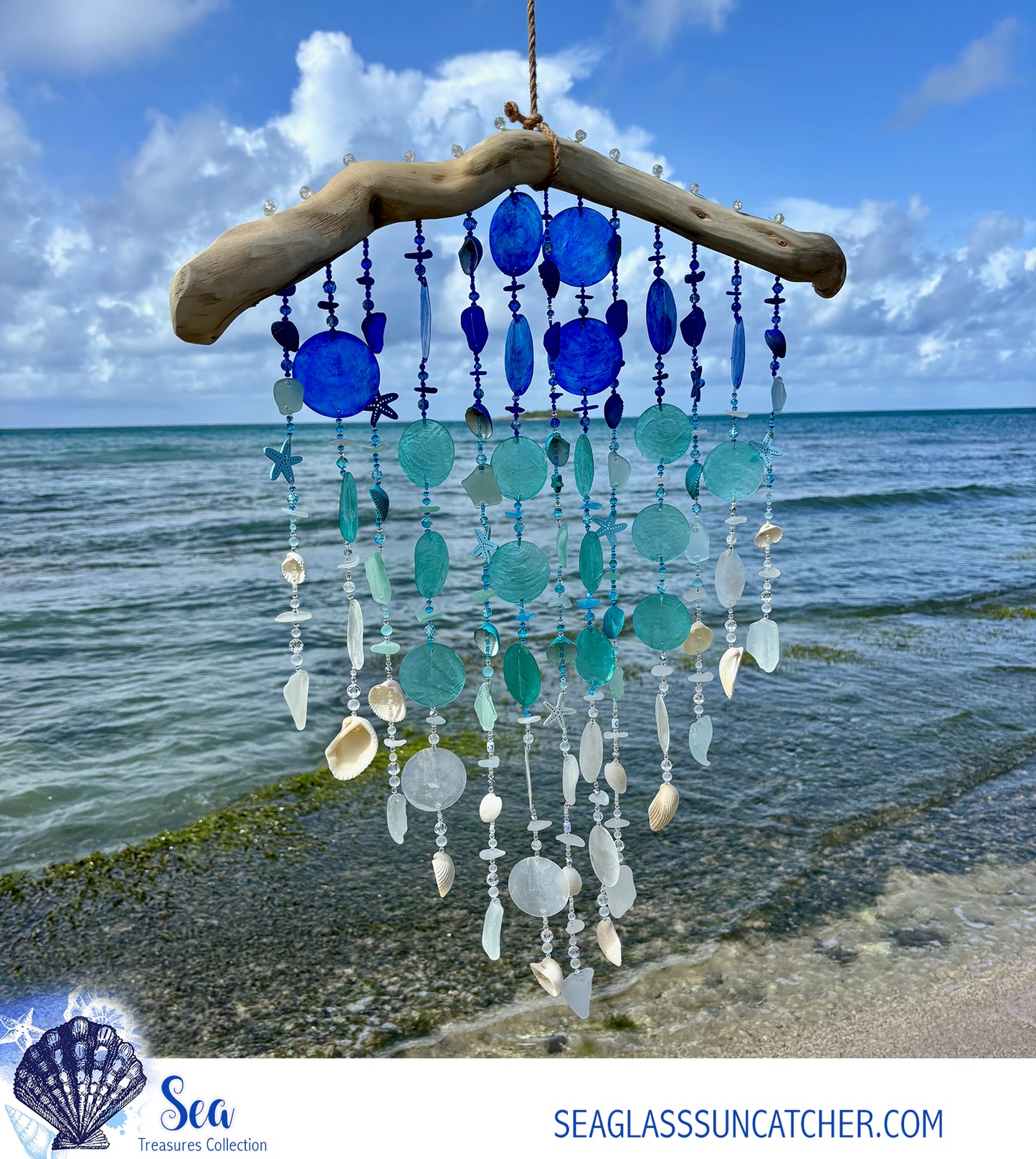 Seaglass suncatcher with blue and white beads hanging against a beach backdrop.i