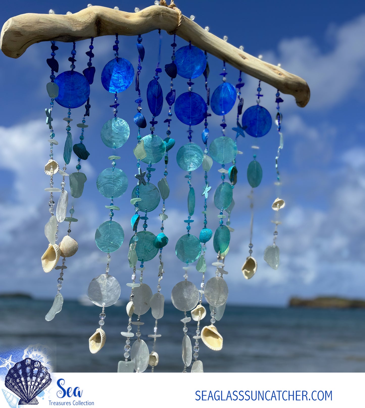 Decorative beach sea glass wind chime with blue and white beads and shells against a beach background.