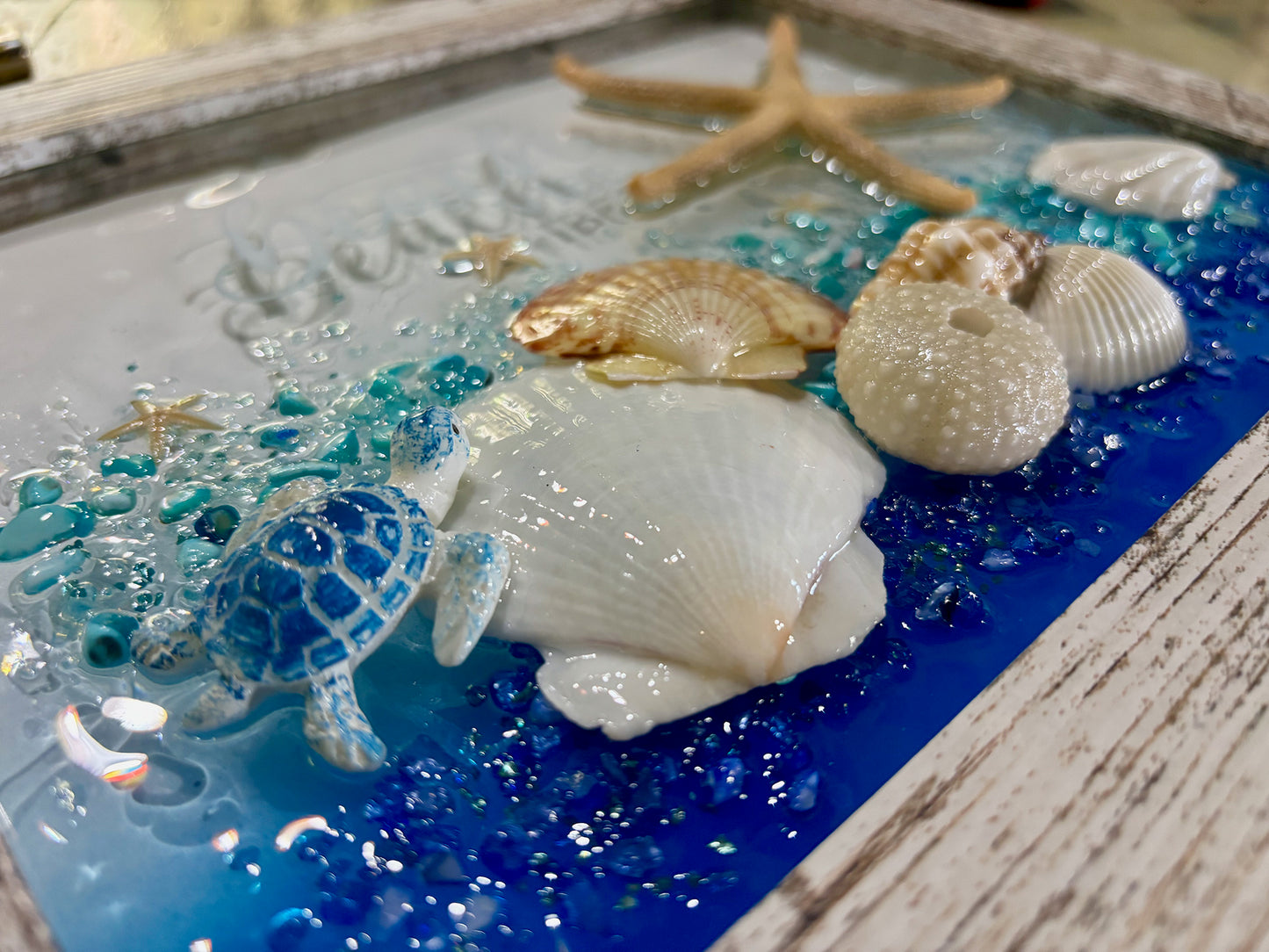 Decorative tray with turtle, shells, and starfish on a blue and white background