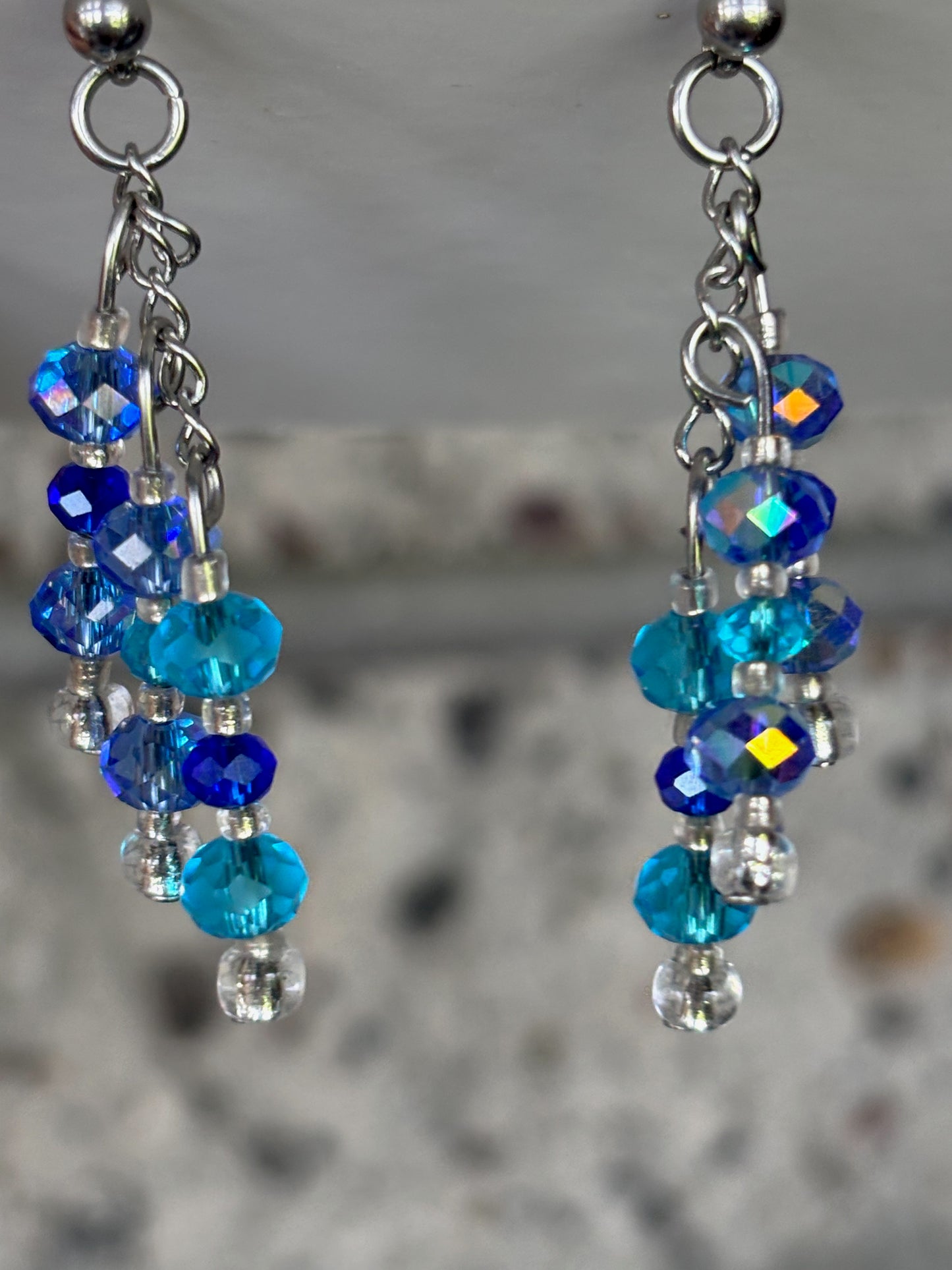 Blue beaded earrings on a blurred background