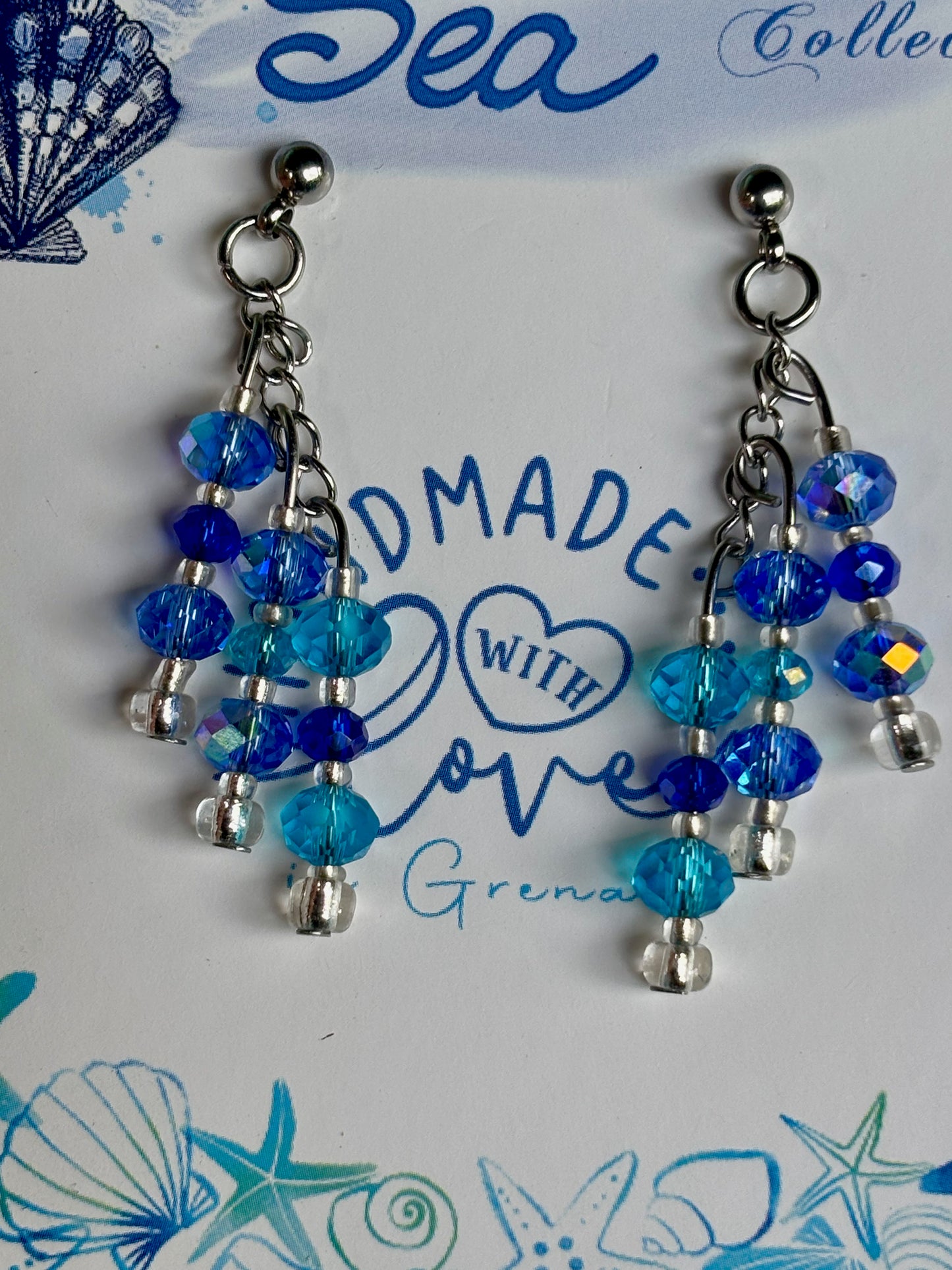 Blue beaded earrings on a card with 'Made with Love' text