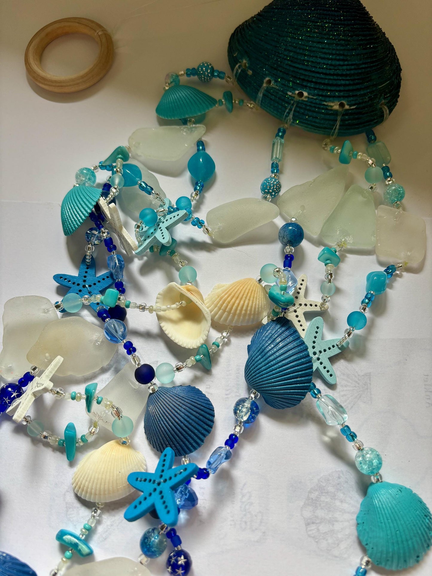 Clam Shell Wind Chime with genuine sea glass, shells, and wooden starfish. Unique Gift for all Beach Lovers