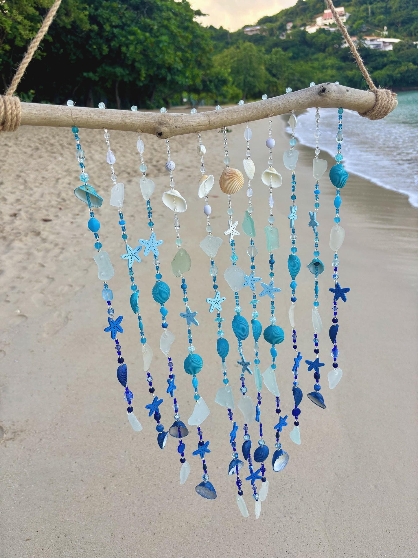 Sea glass and shell wind chime on unique piece of driftwood