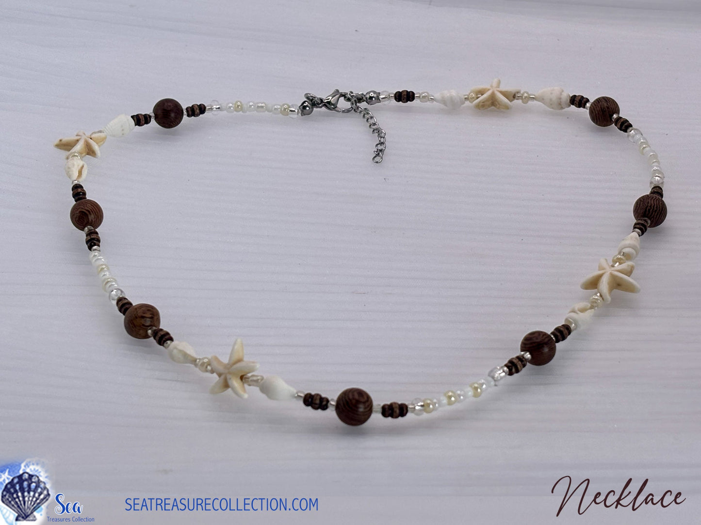 Necklace with starfish and bead details on a white background
