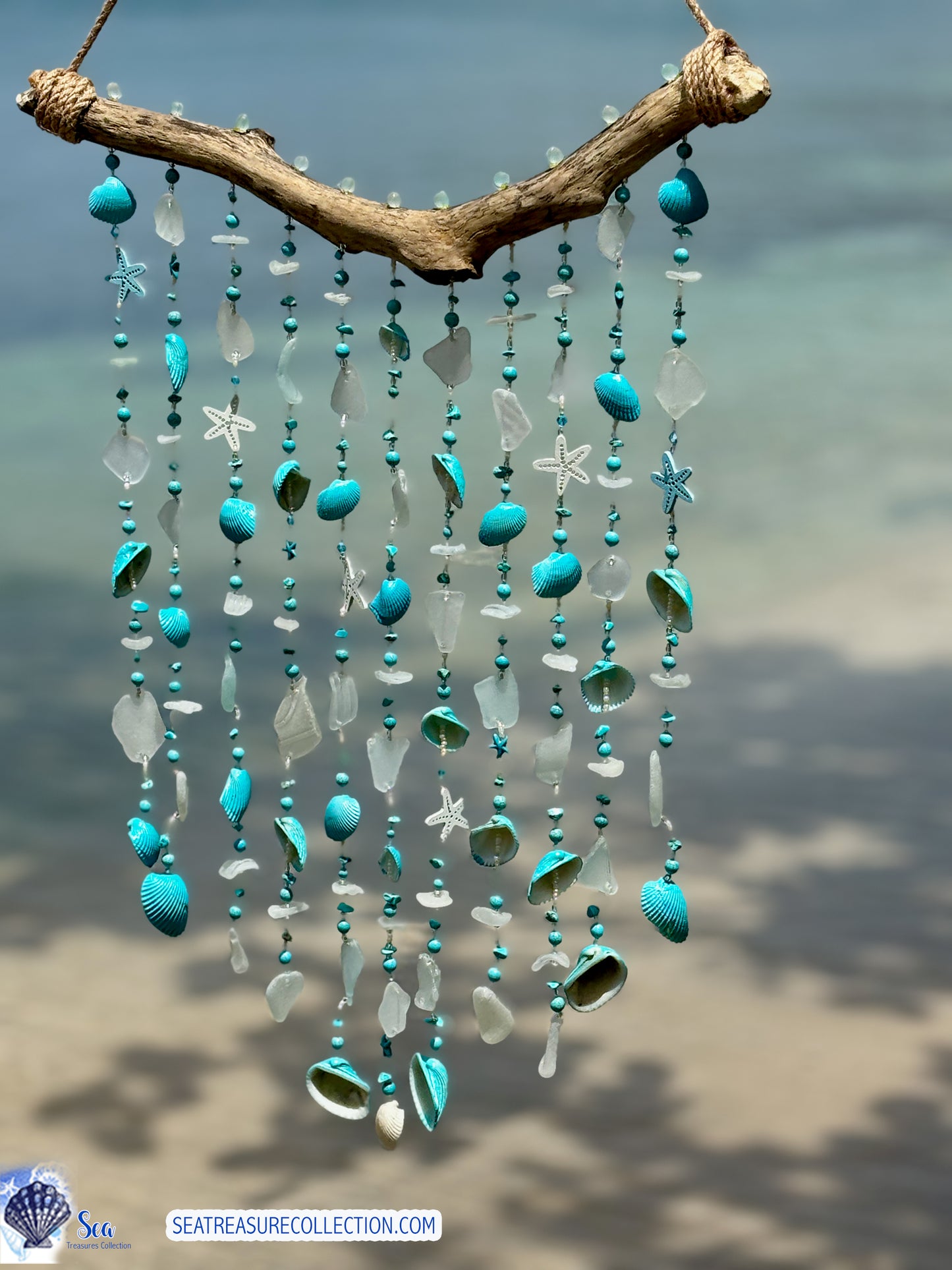 Sea Glass wind chime with turquoise beads and shells against a blurred natural background