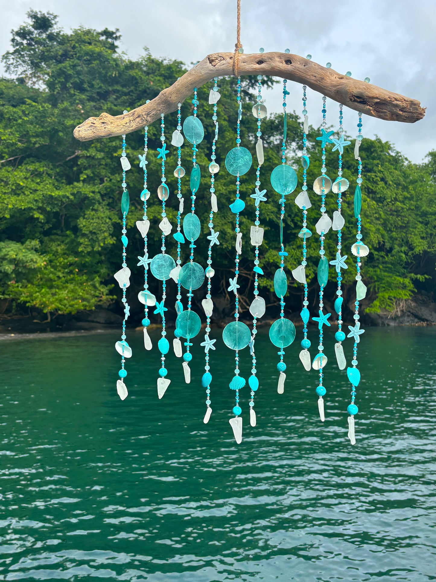 Decorative hanging with beads and stones against a natural background
