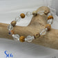 Beaded bracelet with wooden and clear beads on a wooden branch, featuring 'Sea Treasures Collection' branding.