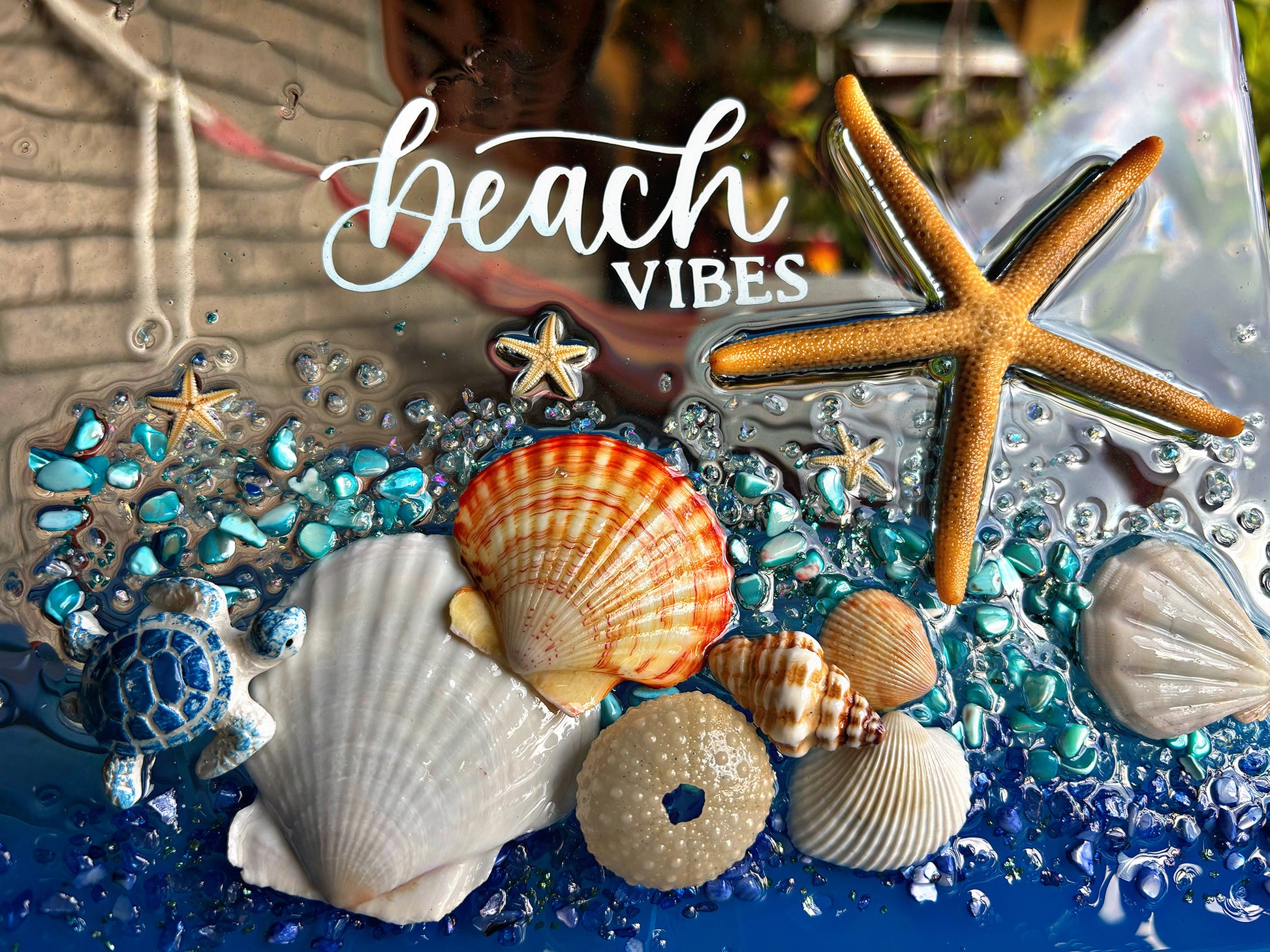 Seashells, starfish, and decorative elements with 'beach vibes' text on a blue and clear background.