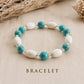 Handmade Caribbean Blue bracelet with turquoise and white wooden beads on elastic cord, handcrafted in Grenada.
