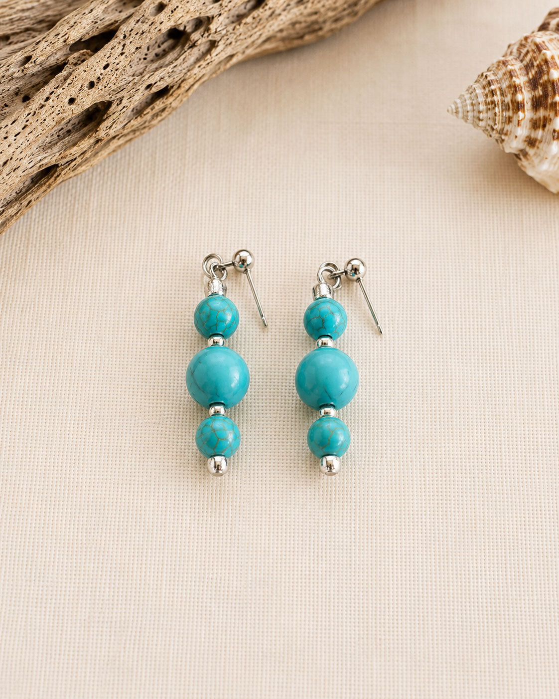 Handmade Caribbean Blue drop earrings featuring turquoise beads and stainless steel findings, handcrafted in Grenada.