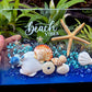 Decorative glass panel with starfish, shells, and 'Beach Vibes' text on a natural background.