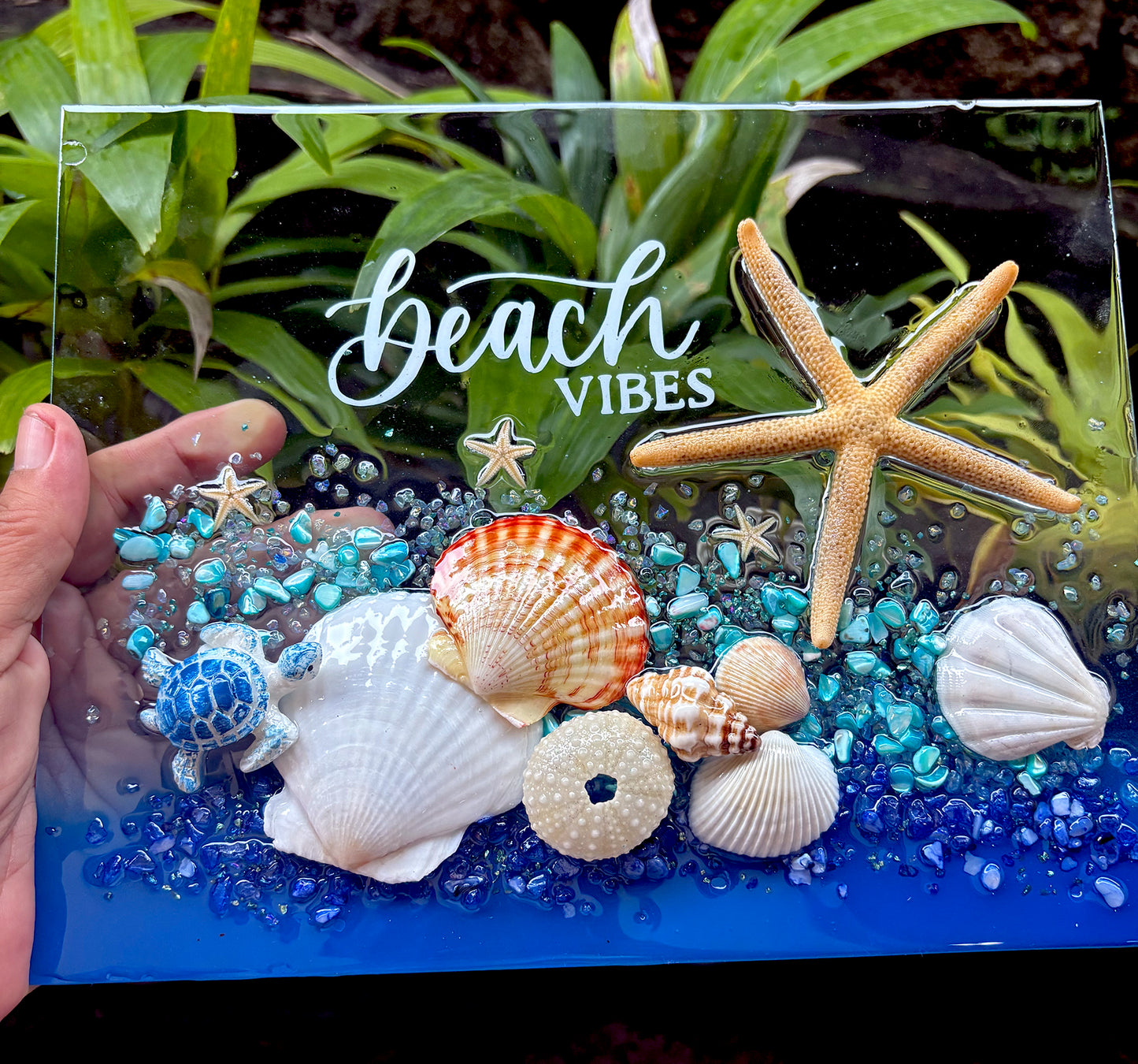 Decorative glass panel with starfish, shells, and 'Beach Vibes' text on a natural background.