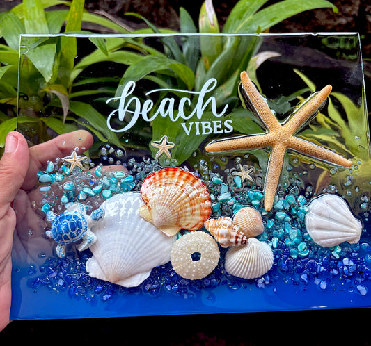 Decorative glass panel with starfish, shells, and 'Beach Vibes' text on a natural background.