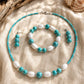 Handmade Caribbean Blue jewellery set with turquoise beads, white wooden beads, necklace, bracelet and earrings by Sea Treasures Collection.