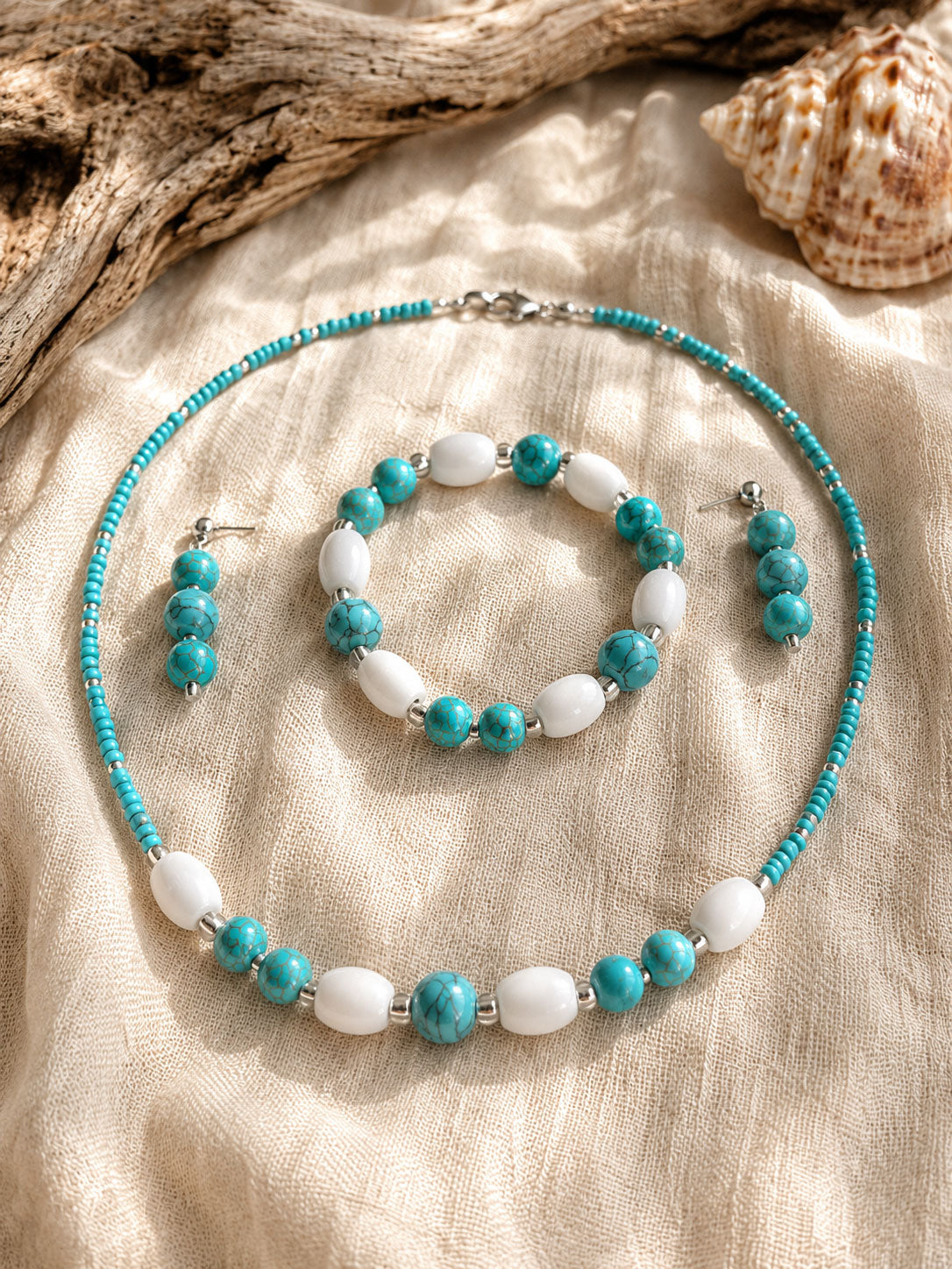 Handmade Caribbean Blue jewellery set with turquoise beads, white wooden beads, necklace, bracelet and earrings by Sea Treasures Collection.