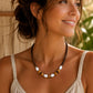 Woman wearing the handmade Island Drift necklace and bracelet inspired by the natural beauty of the Caribbean.
