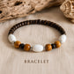 Close-up of the Island Drift handmade bracelet featuring coconut beads, natural wood and white accent beads.