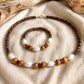 Handmade Island Drift necklace and bracelet featuring coconut beads, natural wood accents and white beads, crafted in Grenada.