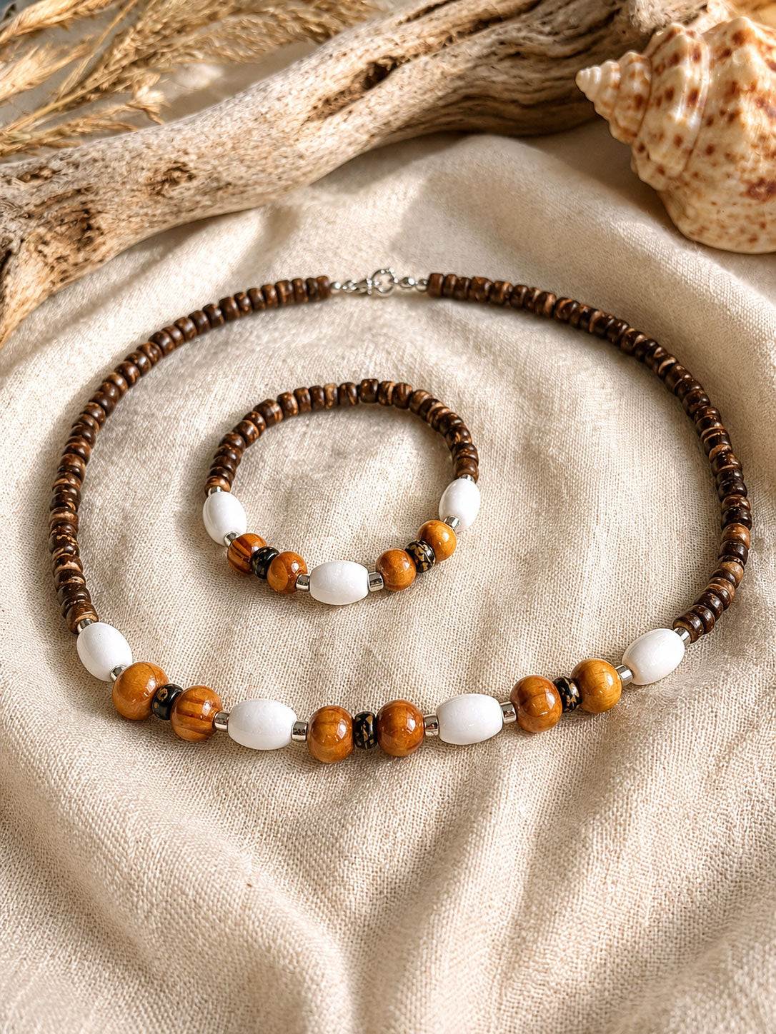 Handmade Island Drift necklace and bracelet featuring coconut beads, natural wood accents and white beads, crafted in Grenada.