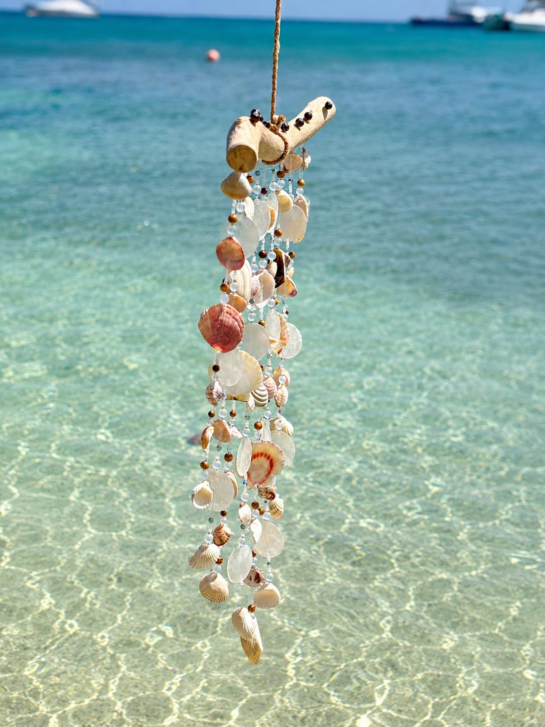 Side profile of the Seashell Serenity Driftwood Wind Chime showing handcrafted shell details.