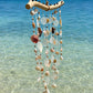 Side profile of the Seashell Serenity Driftwood Wind Chime showing handcrafted shell details.