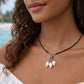 Handmade Whispering Shell Necklace Midnight style with black seed beads, natural shell pendant and stainless steel accents.