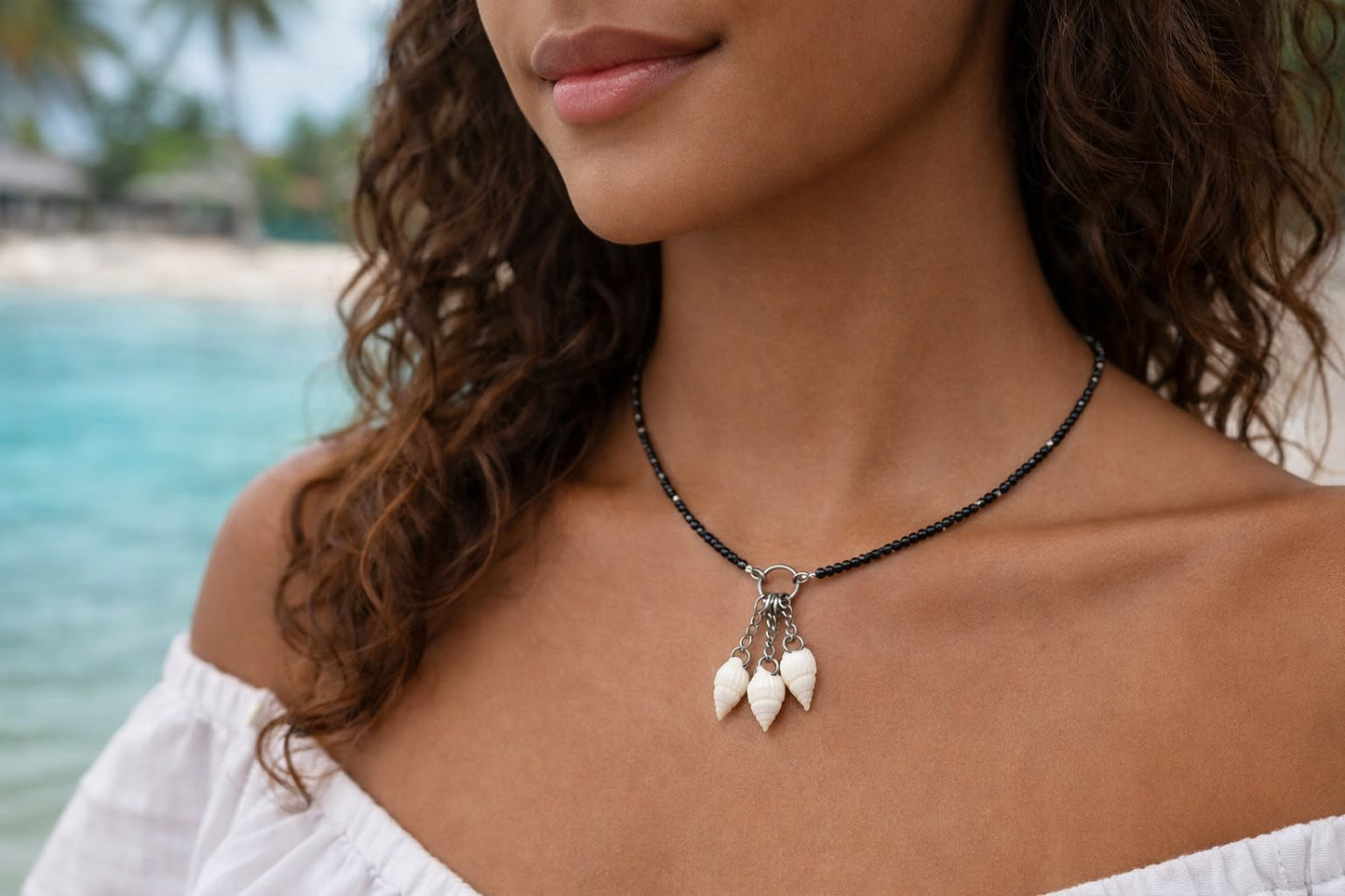 Handmade Whispering Shell Necklace Midnight style with black seed beads, natural shell pendant and stainless steel accents.