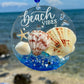 Seaglass suncatcher with shells and starfish against a beach background
