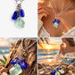 Necklace with blue and green sea glass pendants on a beach setting