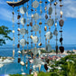 Seaglass suncatcher with a scenic background of a harbor and blue sky.