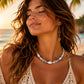 Woman wearing the Ocean Mist Crackle Agate necklace on a tropical beach, showcasing the handcrafted coastal jewellery by Sea Treasures Collection.