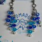 Blue beaded earrings on a card with 'Made with Love' text