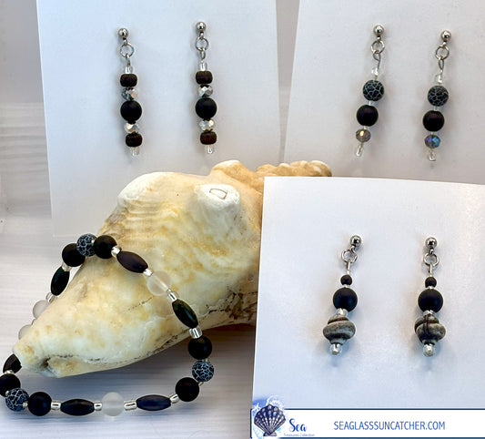 Black beaded jewelry set with a shell and card displaying 'Sea Glass Treasures Collection' branding.