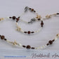 Necklace and anklet set with starfish and bead design on a white background