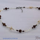 Necklace with starfish and bead details on a white background