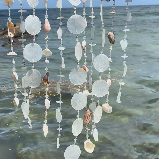 Video of white tropical beach windchime