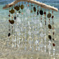 Decorative wind chime with natural elements on a beach