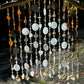 Decorative white, brown sea glass wind chime with beads and shells on a natural background