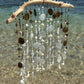 Tropical wind chime with natural elements on a beach